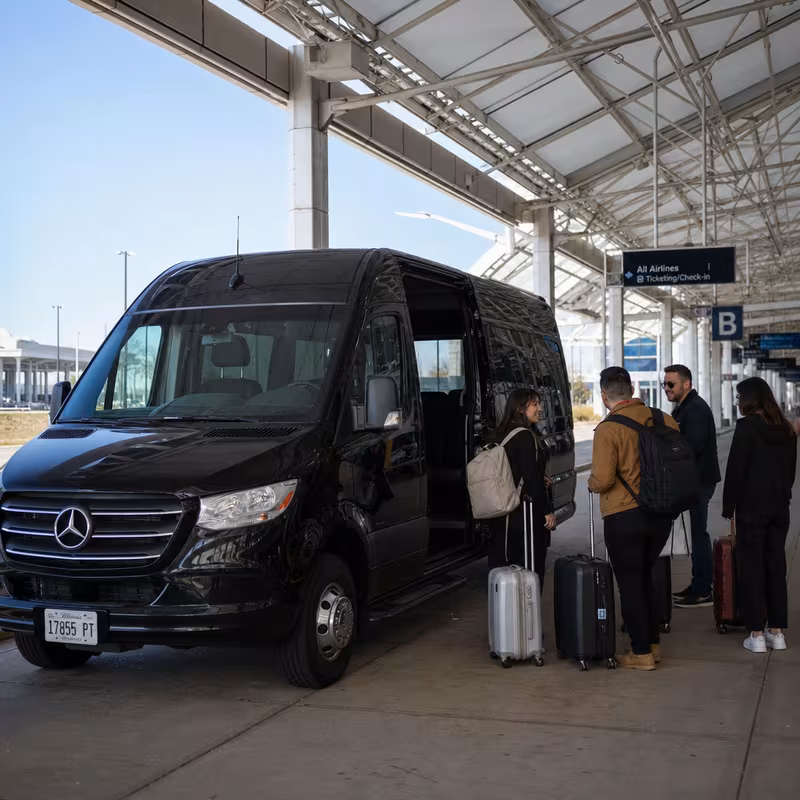 Group boarding a white charter bus for Airport Transportation transportation in Naperville