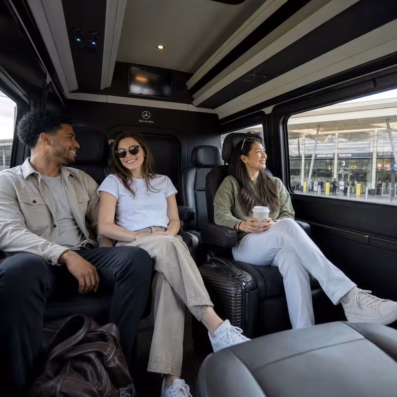 Passengers loading luggage while boarding an Naperville group shuttle