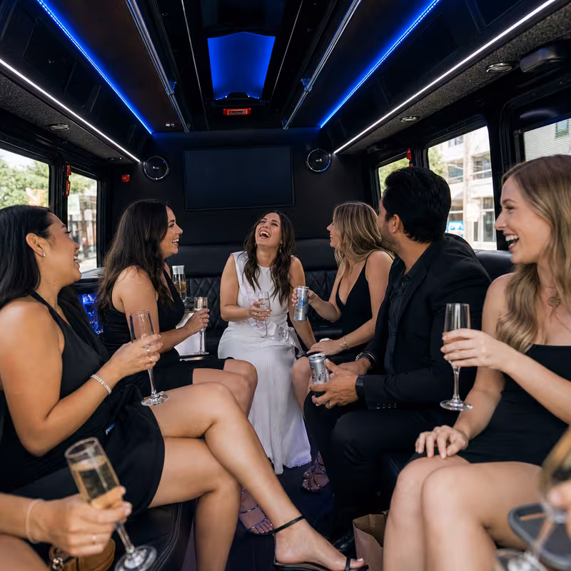 Party bus interior with wraparound leather seating and LED lighting in Naperville