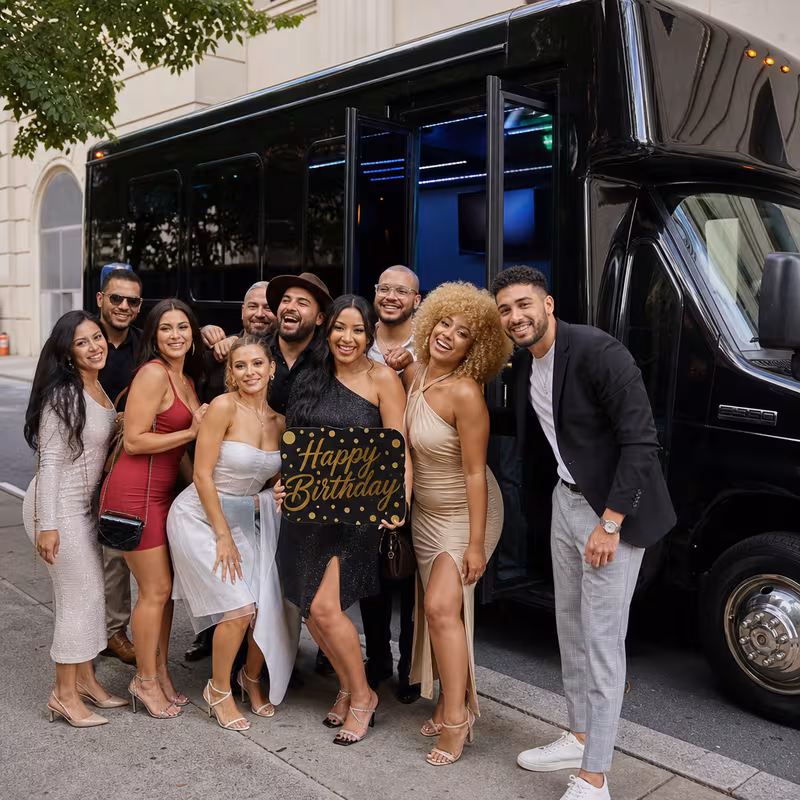 Group boarding a white charter bus for Birthday Transportation transportation in Naperville