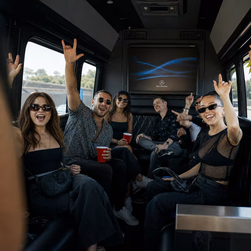 Group boarding a white charter bus for Concert Transportation transportation in Naperville