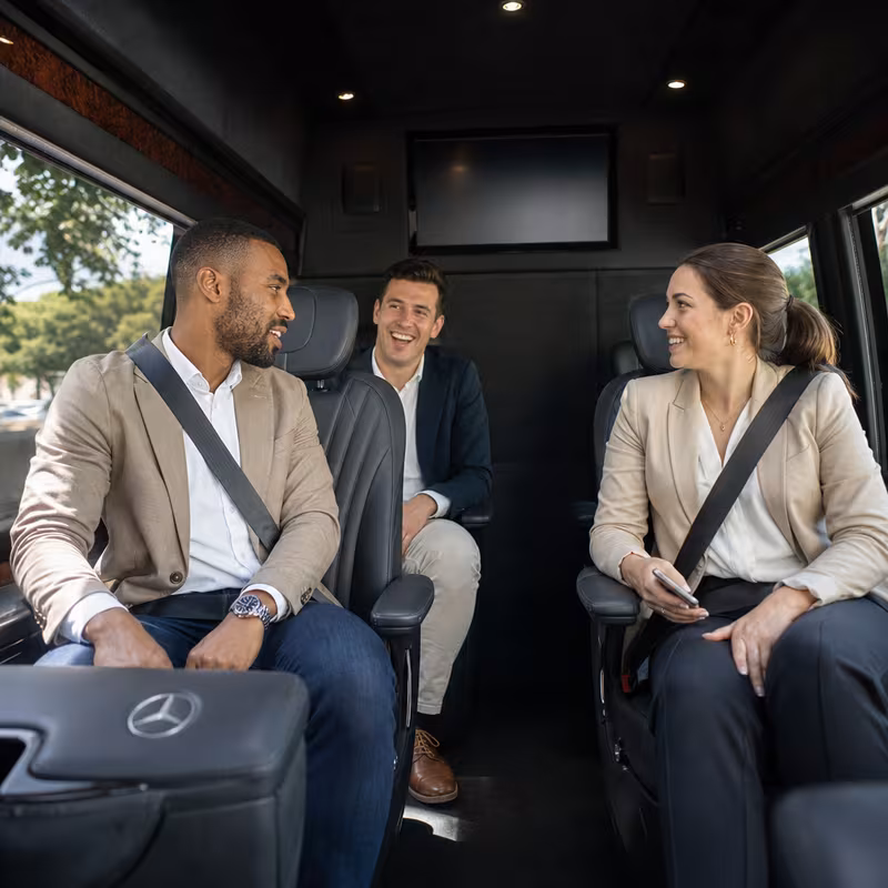 Group boarding a white charter bus for Corporate Transportation transportation in Naperville