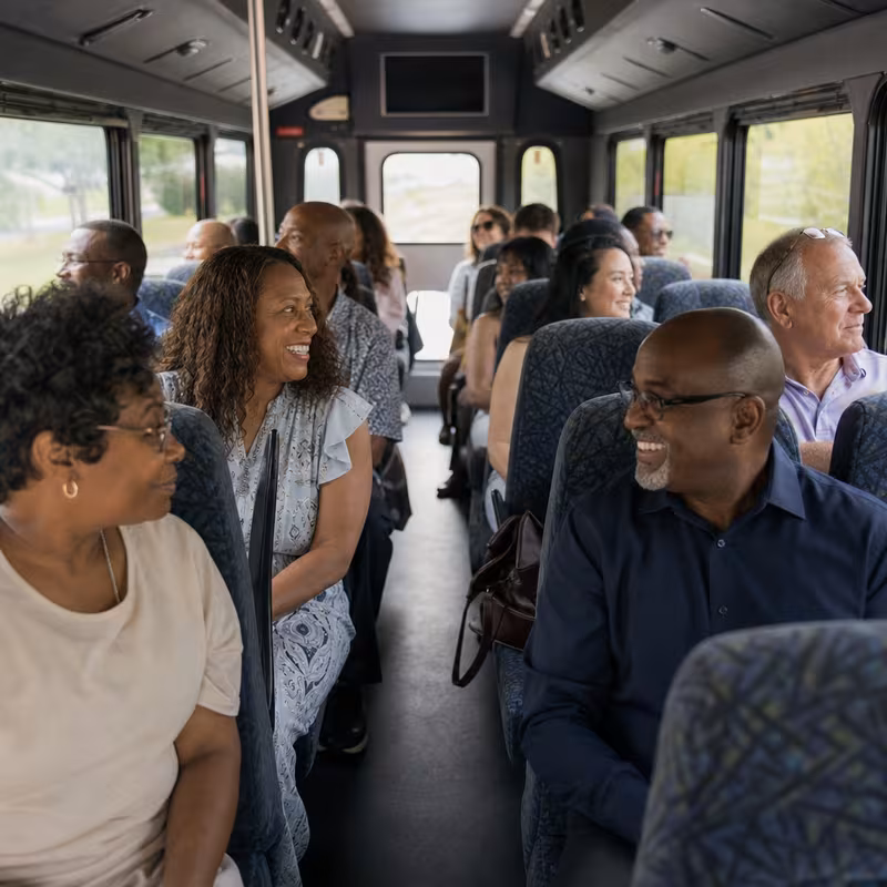 Group boarding a white charter bus for Private Event Transportation transportation in Naperville