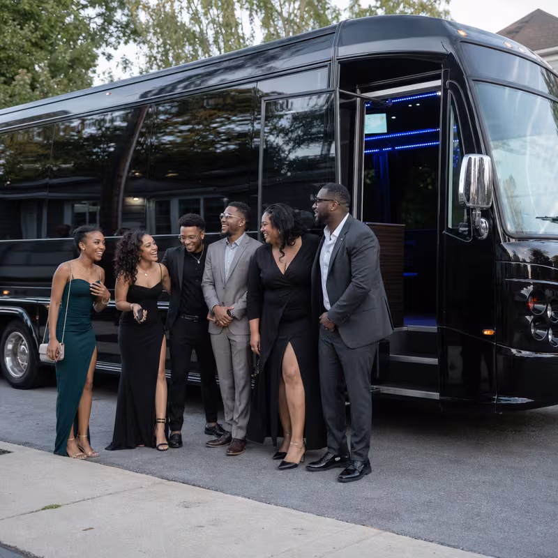 Passengers loading luggage while boarding an Naperville group shuttle
